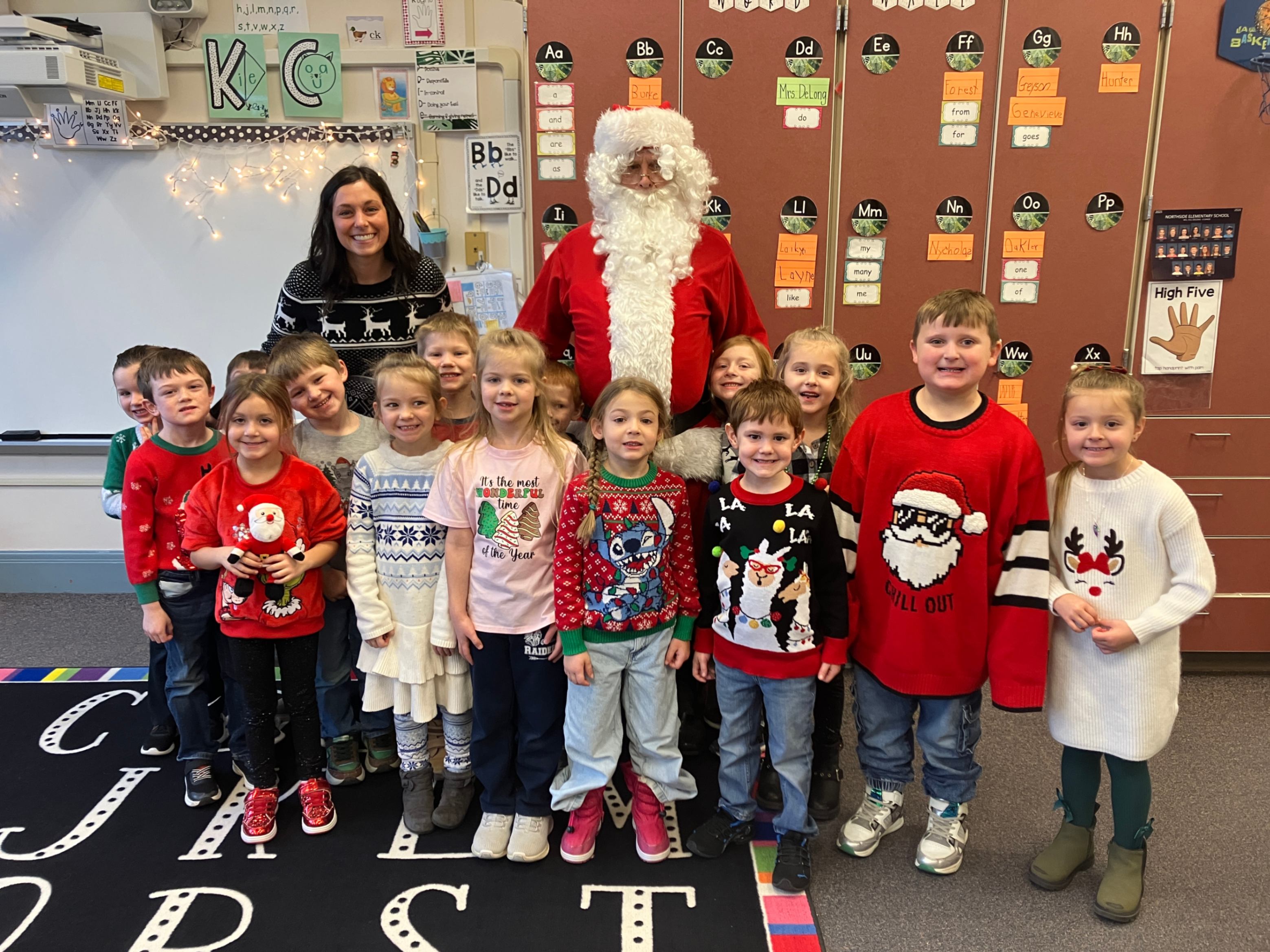 Santa poses for a photo with students from Mrs. DeLong's kindergarten class.